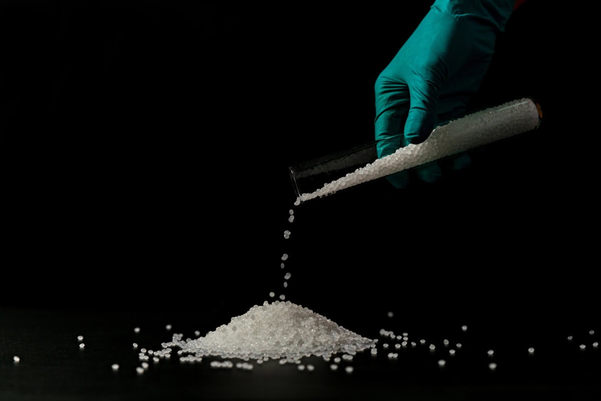 Close-up of plastic polymer granules. hand hold Polymer pellets.